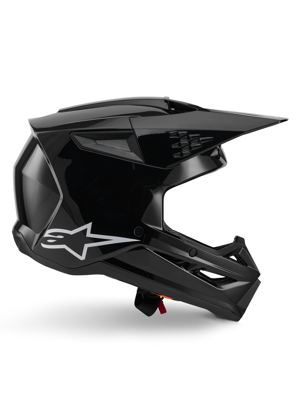 Alpinestars S-M3 Solid Helm, Motocross-Helm, Schwarz glänzend, Seitenprofilansicht mit weißem Stern-Logo, kantiges aerodynamisches Design mit Mesh-Belüftungsöffnungen und Visier, schützende Offroad-Rennsport-Kopfbedeckung