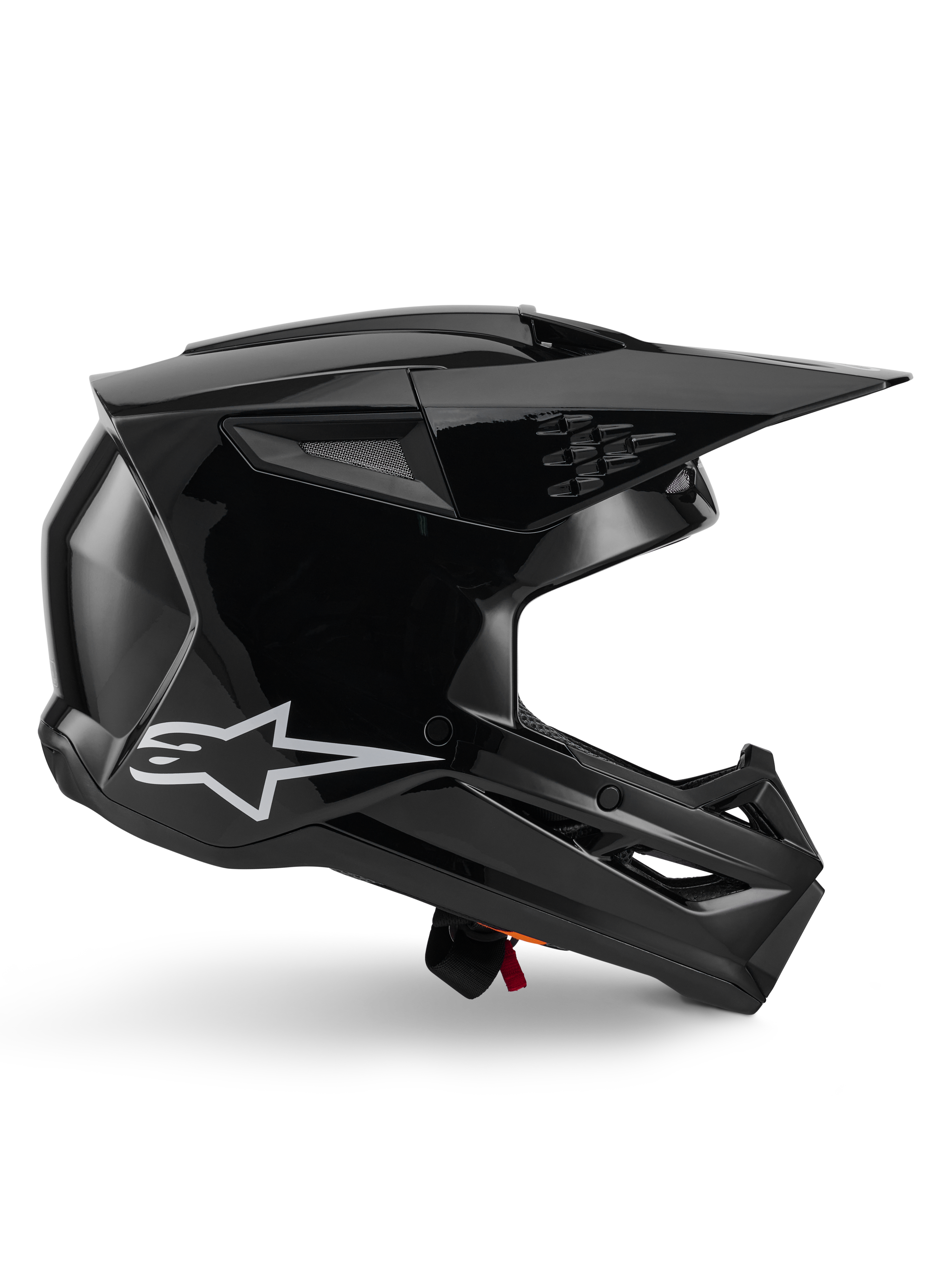 Casque Alpinestars S-M3 Solid, casque de motocross, noir brillant, vue de profil avec un logo étoile blanc, design aérodynamique angulaire avec aérations mesh et visière, équipement de protection pour la course tout-terrain