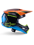Alpinestars S-M3 Fray Helm ECE 22.06, motorcrosshelm, zwart, oranje, blauw en neongeel, zijprofiel van een glanzende aerodynamische schaal met een opvallende oranje klep, neongroene branding en blauwe accenten, off-road racebescherming
