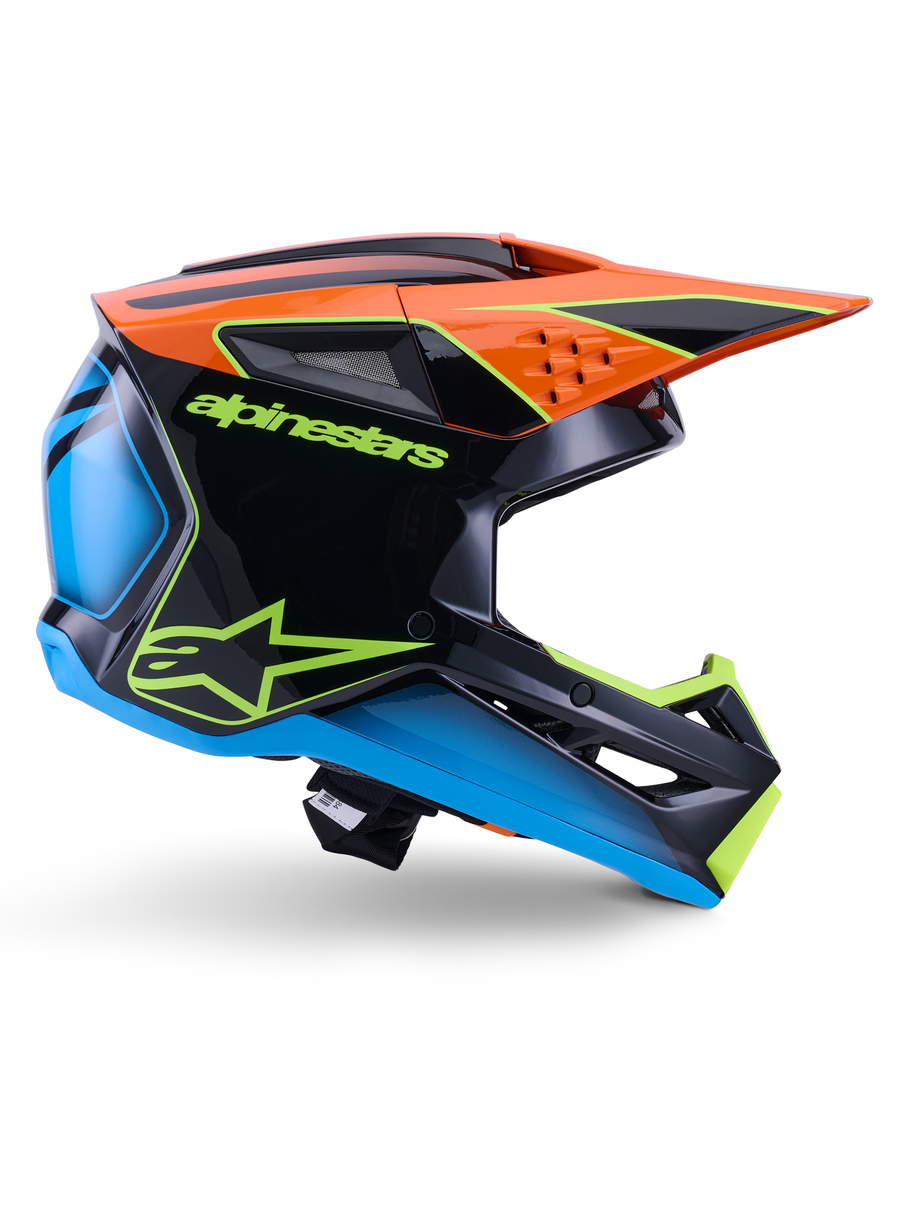Casque Alpinestars S-M3 Fray ECE 22.06, casque de motocross, noir, orange, bleu et jaune fluo, profil latéral d'une coque aérodynamique brillante avec une visière orange proéminente, logos vert fluo et détails bleus, protection pour la course tout-terrain