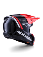 Casque Alpinestars S-M3 Radium, casque de motocross, noir, rouge fluo et blanc brillant, vue de trois-quarts arrière montrant un design aérodynamique épuré, logos blancs et visière rouge vif, équipement de protection haute performance pour le tout-terrain