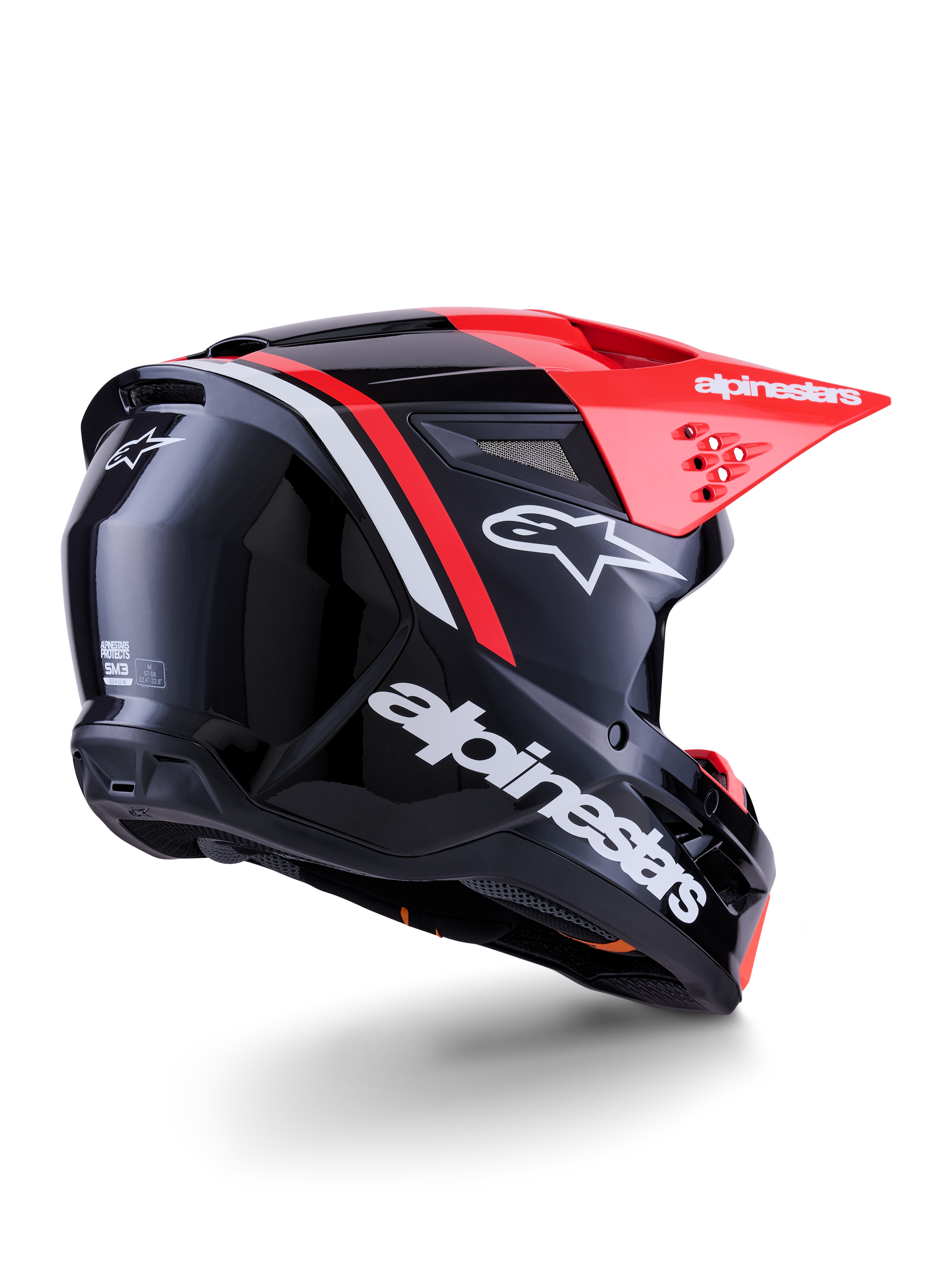 Casque Alpinestars S-M3 Radium, casque de motocross, noir, rouge fluo et blanc brillant, vue de trois-quarts arrière montrant un design aérodynamique épuré, logos blancs et visière rouge vif, équipement de protection haute performance pour le tout-terrain