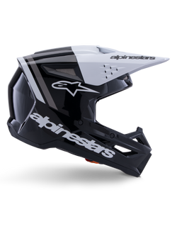 Casque Alpinestars S-M3 Radium, casque de motocross tout-terrain, noir, blanc et gris brillant, design aérodynamique angulaire avec ports de ventilation, vue de profil, finition brillante avec bandes grises et visière blanche avec logo Alpinestars