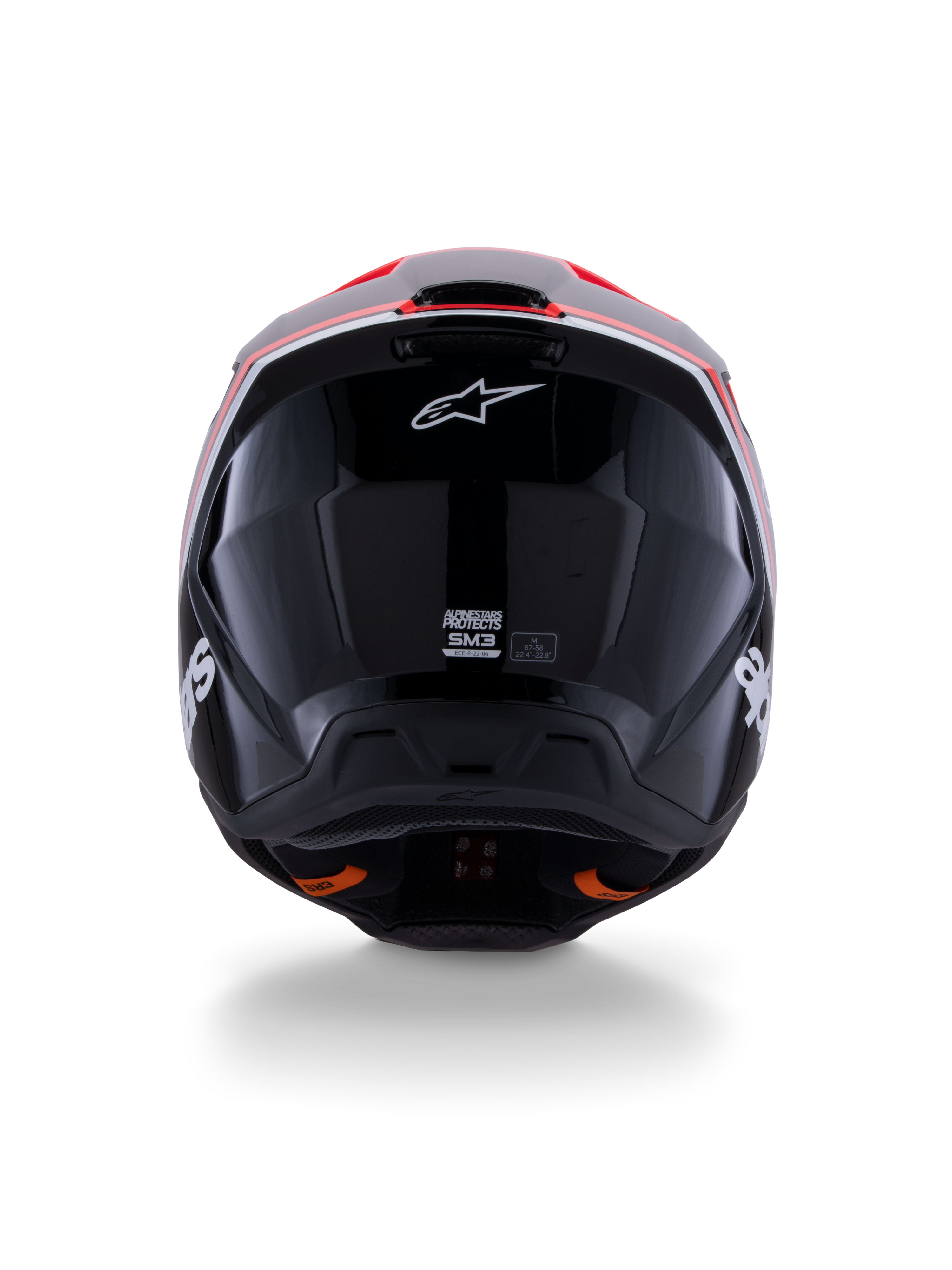 Casque Alpinestars S-M3 Radium ECE 22.06, casque de motocross, noir brillant avec des accents rouge fluo et blanc, vue arrière montrant la conception aérodynamique de la coque, le logo étoile blanc et les étiquettes de certification.