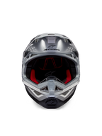 Casque Alpinestars Supertech M10 Flood ECE 22.06, casque de motocross, argenté, noir et orange fluo, vue de face présentant une coque aérodynamique, une large ouverture faciale avec rembourrage intérieur rouge, logo Alpinestars noir et mentonnière ventilée pour la course tout-terrain