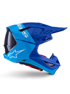 Alpinestars Supertech M10 Flood Helmet, Motocross Helmet, Metallic and Medium Blue with Black Carbon accents, side profile view, featuring a white logo, aerodynamic design with ventilation ports, carbon fiber texture details, professional off-road racing protection