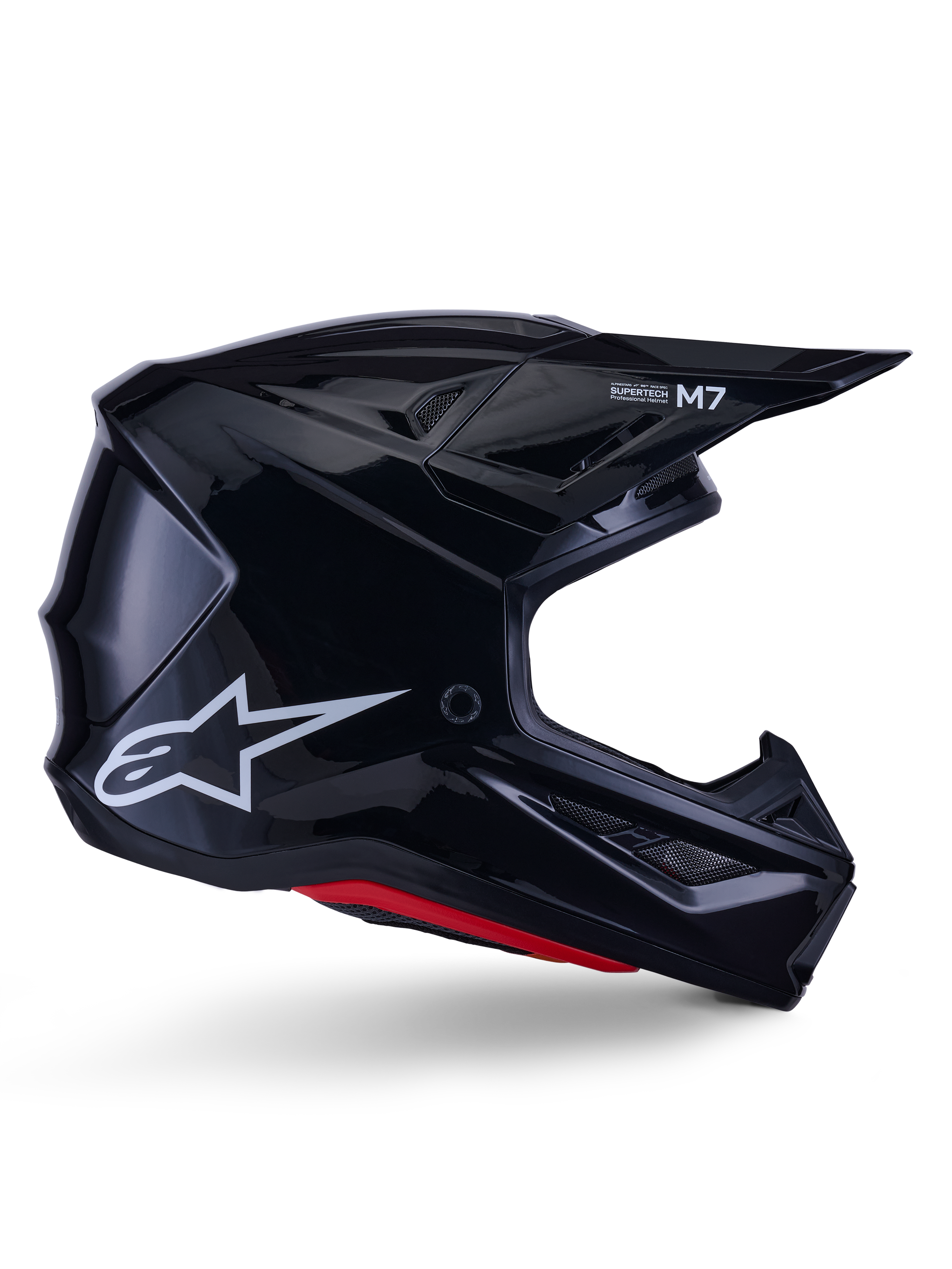Alpinestars S-M7 Solid Helm, Motocross-Rennhelm, Glänzend Schwarz mit weißem Stern-Logo und roten Akzenten, Seitenprofil mit aerodynamischem Design, eckigen Mesh-Belüftungsöffnungen und Supertech M7-Branding auf dem Visier.