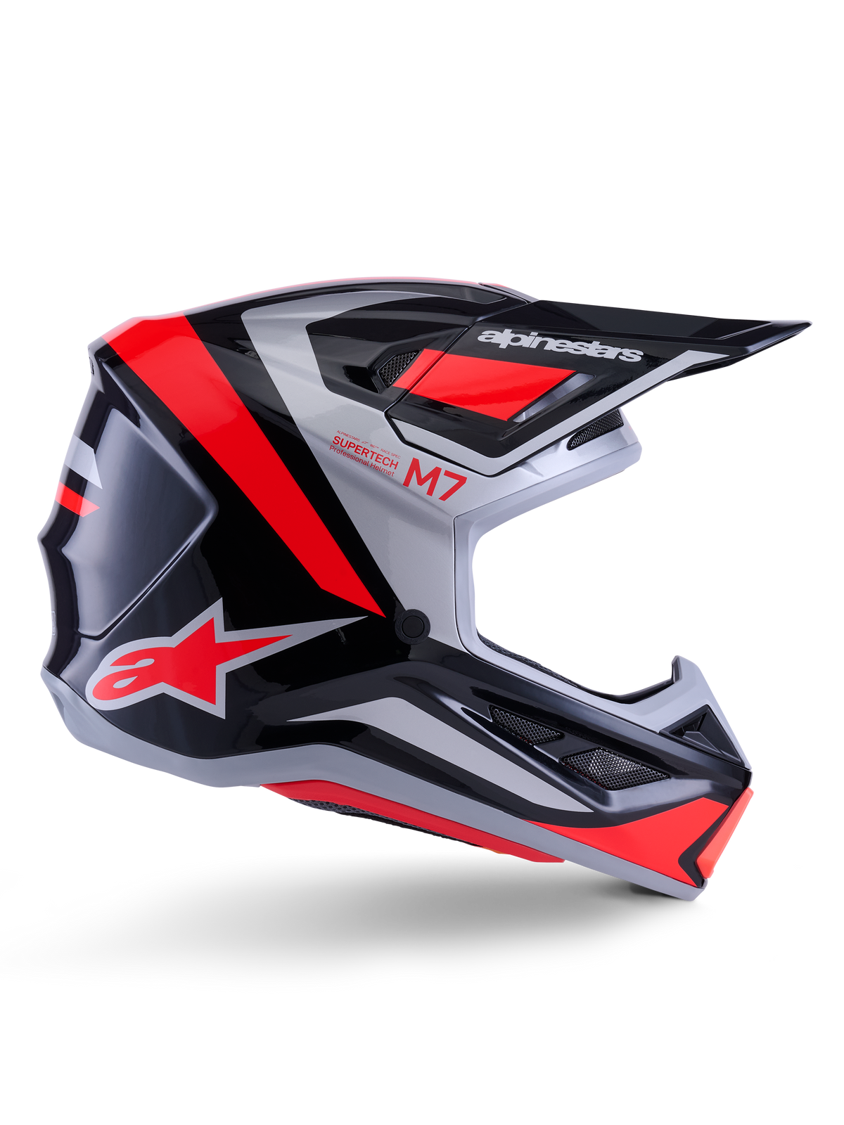 Alpinestars S-M7 Rise Helm, Motocross-Helm, Schwarz, Silber und Rot Fluo, Seitenansicht mit kantigem aerodynamischem Design, Helmschild und Belüftungsöffnungen, glänzende Oberfläche, Supertech M7 Serie