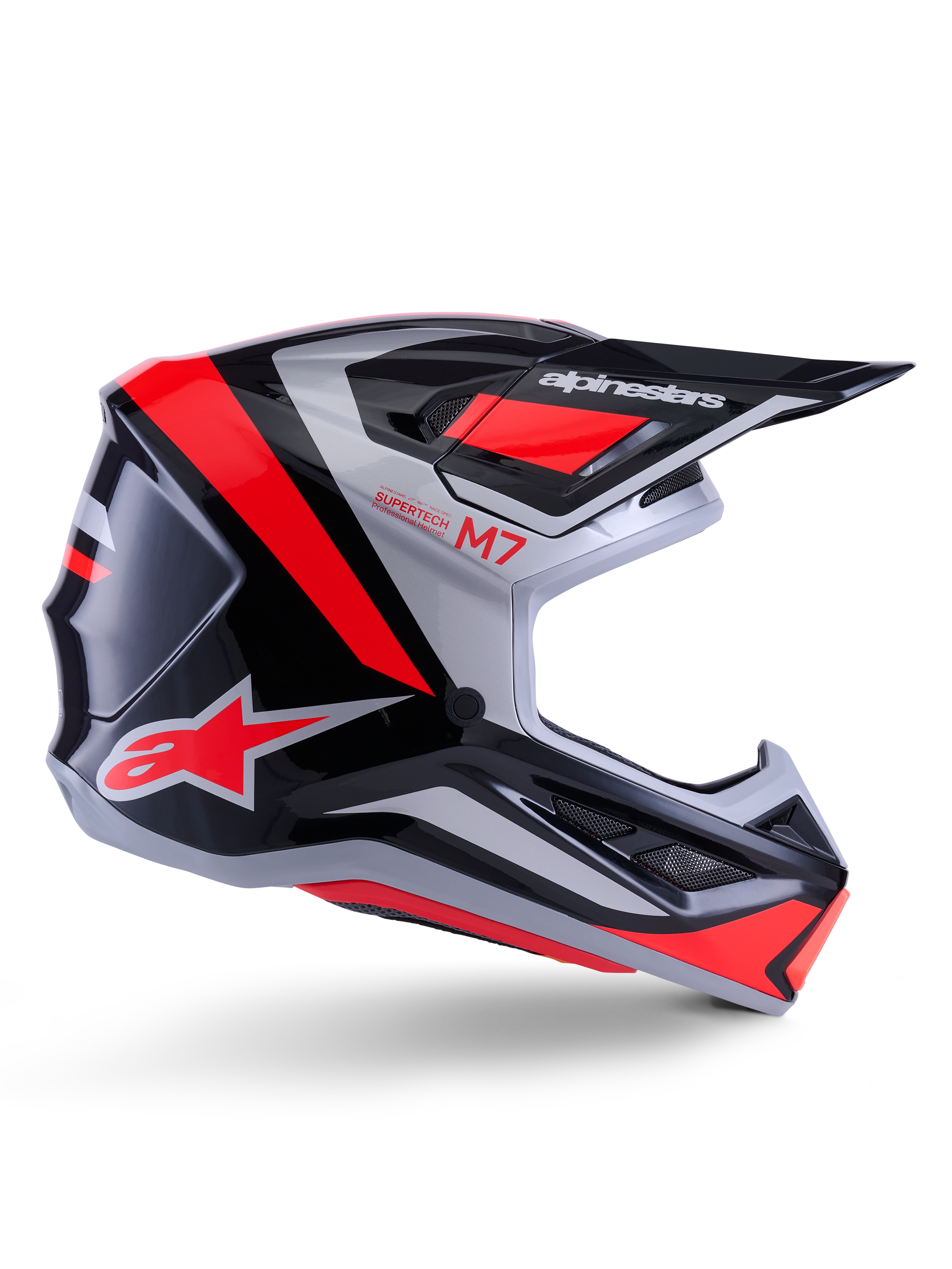 Alpinestars S-M7 Rise Helm, Motocross-Helm, Schwarz, Silber und Rot Fluo, Seitenansicht mit kantigem aerodynamischem Design, Helmschild und Belüftungsöffnungen, glänzende Oberfläche, Supertech M7 Serie