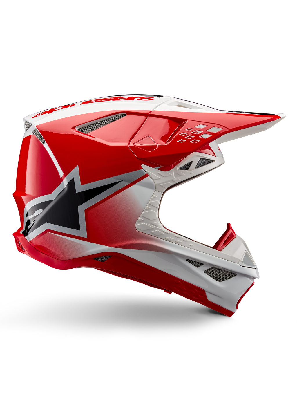 Casque Alpinestars Supertech M10 Unite, casque de motocross, rouge et blanc brillant, présentant une vue de profil avec des motifs géométriques angulaires, un graphique d'étoile noire, de multiples aérations en maille et un design aérodynamique pour la course tout-terrain