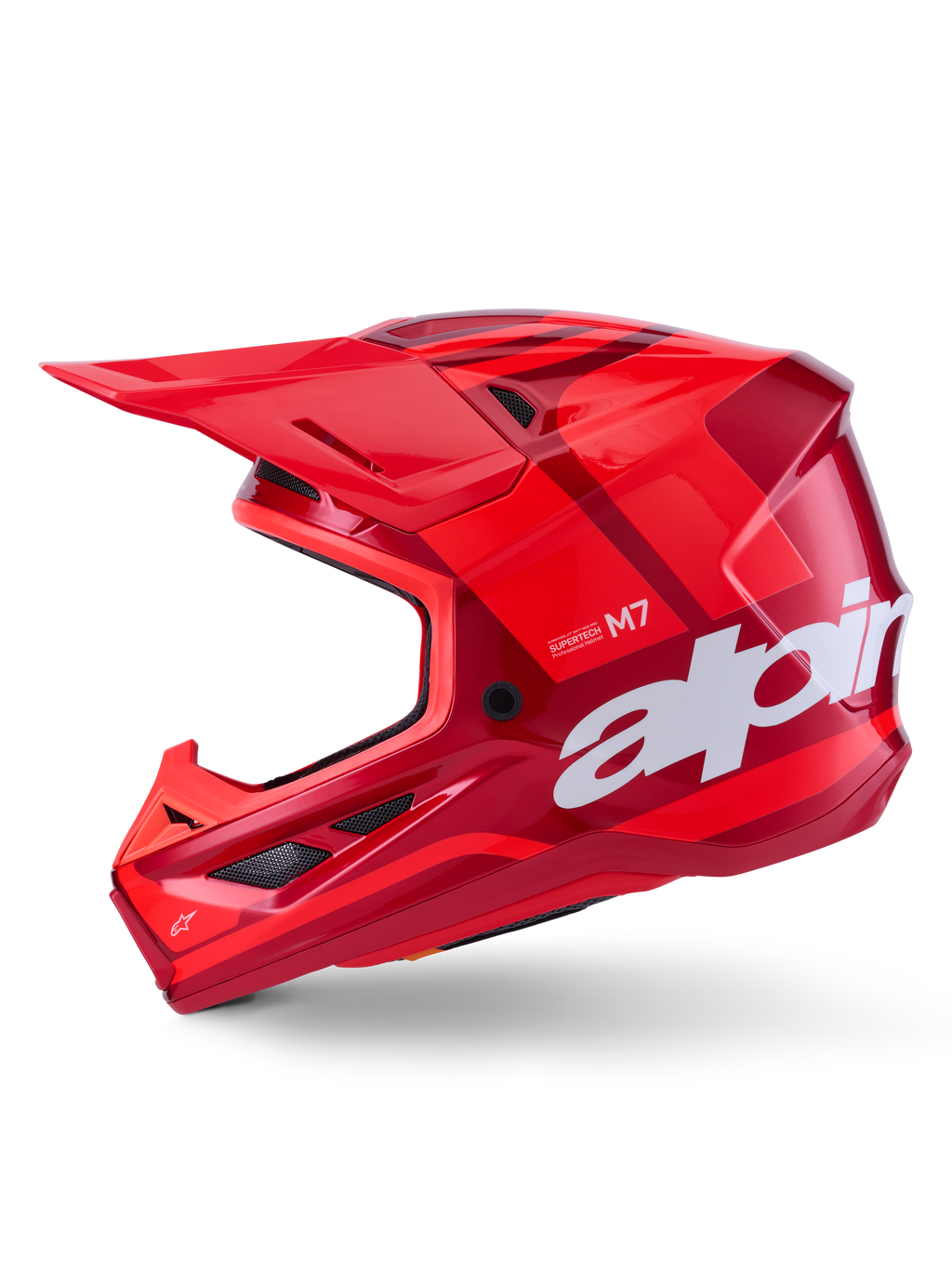 Alpinestars S-M7 Core Helm, glanzend rood met geometrische accenten, motorcrosshelm, zijaanzicht, aerodynamische schaal met ventilatieopeningen en witte logo's, hoogwaardige off-road race-uitrusting