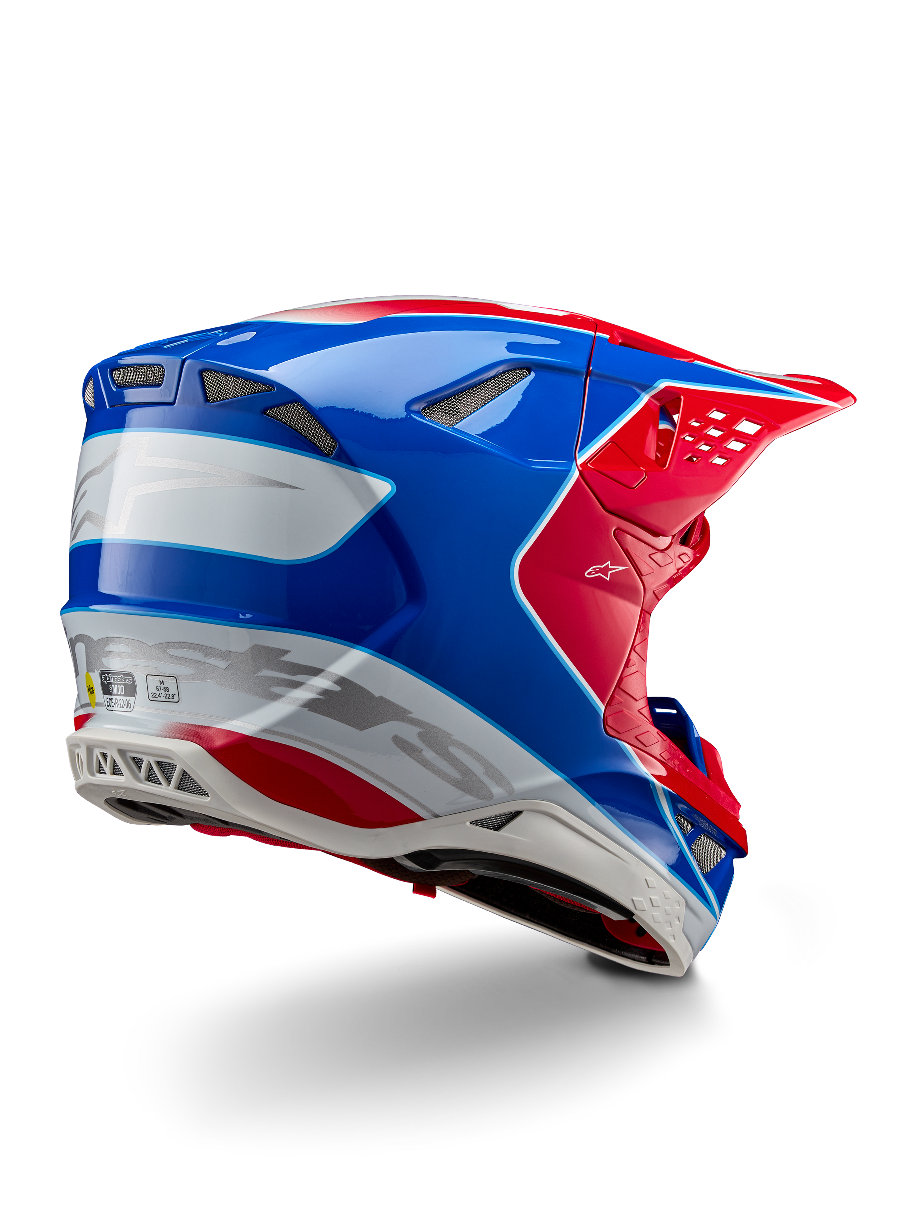 Casque Alpinestars Supertech M10 Aeon ECE 22.06, casque de motocross, rouge vif, bleu et blanc brillant, vue latérale arrière présentant un profil aérodynamique, marquage Alpinestars argenté et orifices de ventilation intégrés.