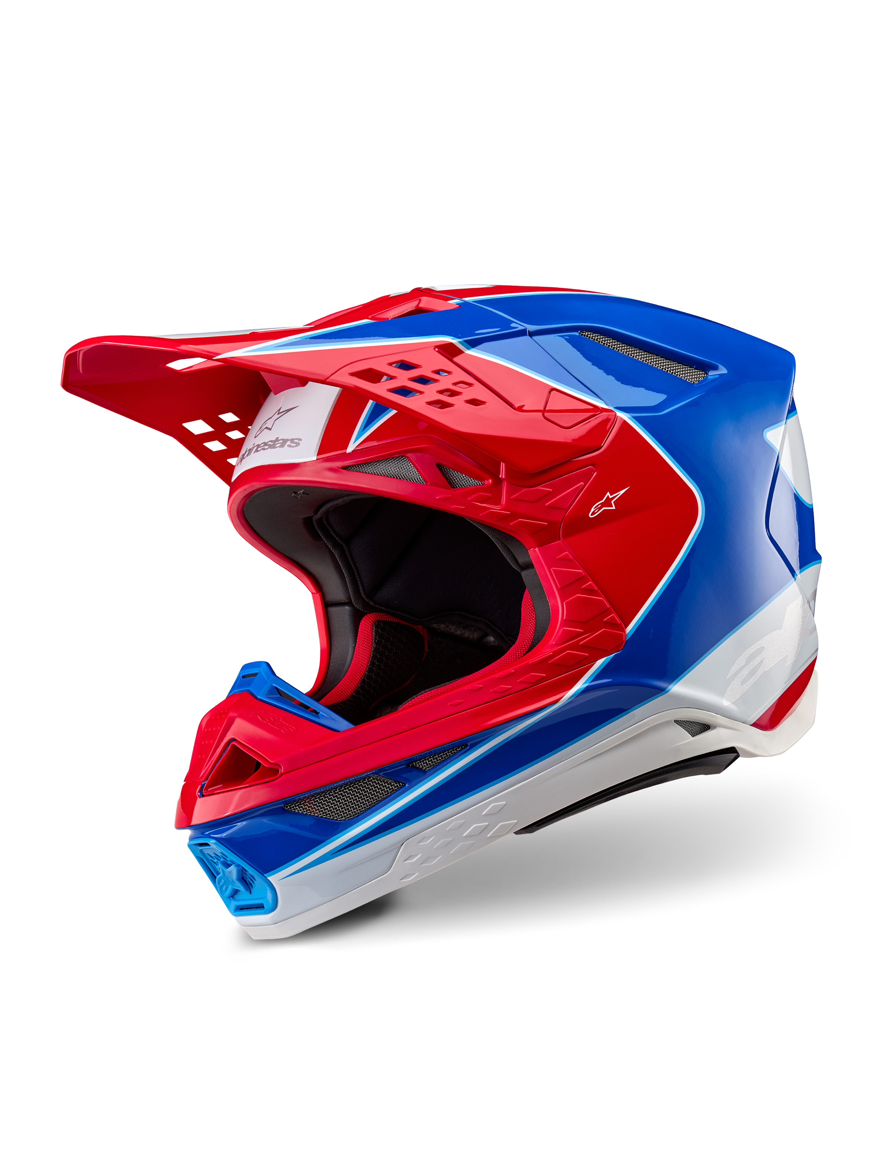 Casque Alpinestars Supertech M10 Aeon, casque de motocross, rouge et bleu brillant, vue de trois-quarts montrant la coque aérodynamique avec de multiples orifices de ventilation, accents graphiques blancs et rouges, logo Alpinestars sur la visière et le côté, équipement de course tout-terrain professionnel