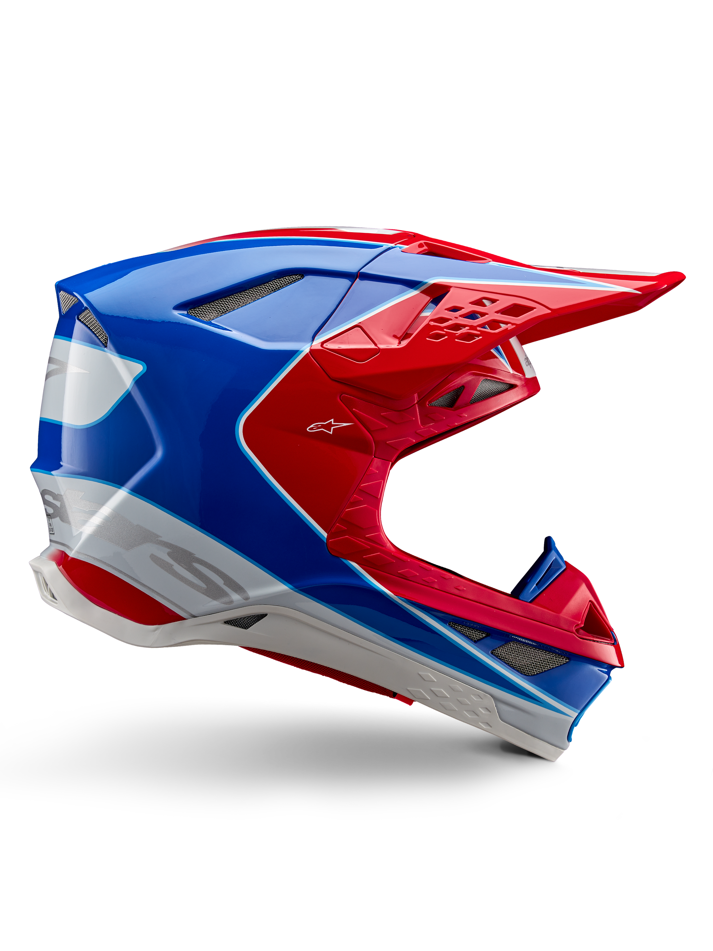 Alpinestars Supertech M10 Aeon, casque de motocross, rouge vif, bleu et blanc, finition brillante, profil latéral aérodynamique avec de multiples aérations en mesh, contours angulaires et visière