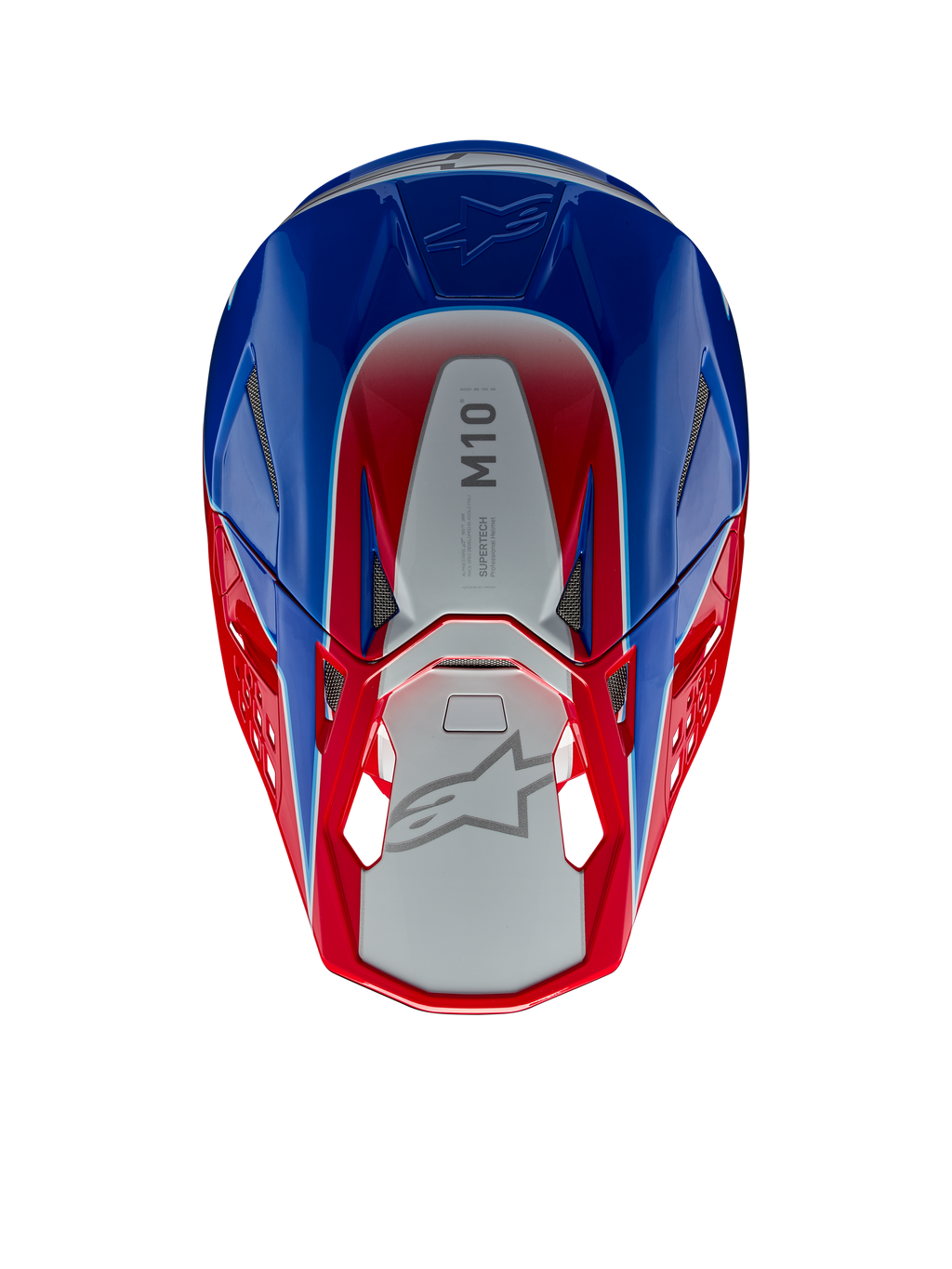 Casque Alpinestars Supertech M10 Aeon, casque de motocross, rouge vif et bleu brillant, vue de dessus montrant le panneau central argenté avec marquage M10, coque aérodynamique avec accents rouges et bleus, grilles de ventilation en maille, protection de tête haute performance pour le motocross