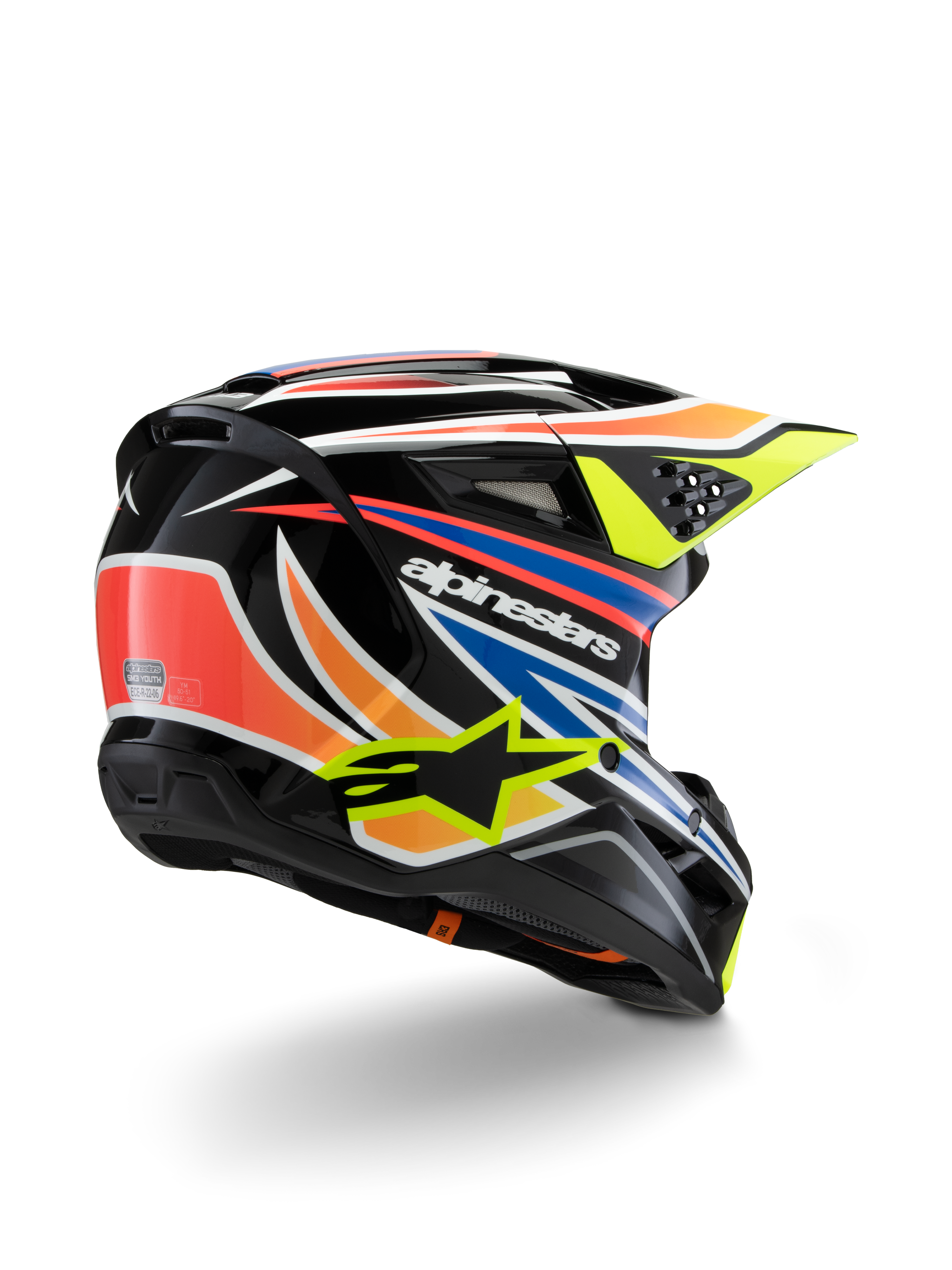Alpinestars S-M3 Youth Wurx helm, jeugd motorcrosshelm, zwart met levendig oranje, rode, blauwe en fluorescerend gele accenten, driekwart achteraanzicht met aerodynamische schaal en ventilatieopeningen, glanzende afwerking met opvallende Alpinestars-branding