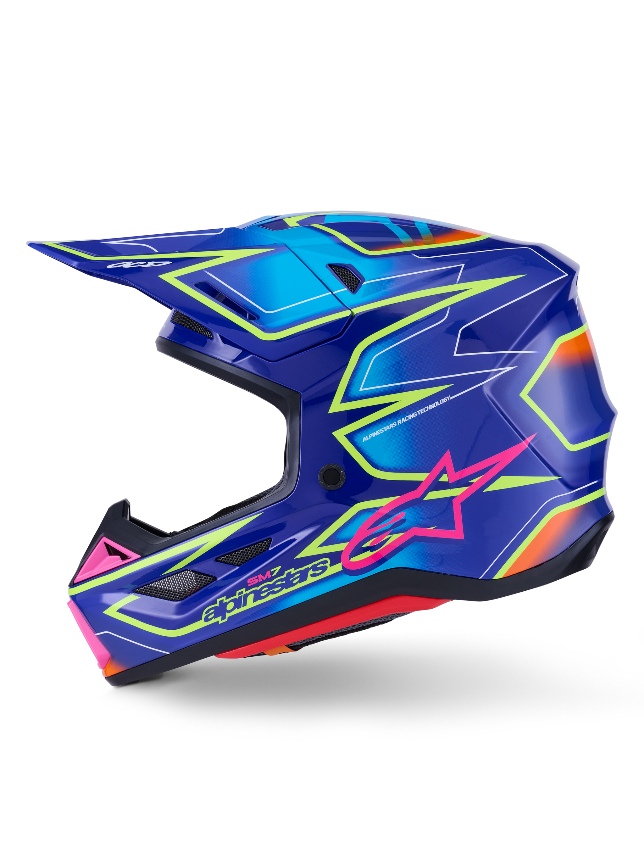 Alpinestars S-M7 Cast Helm, motorcrosshelm, blauw met roze en fluogeel glanzende accenten, zijaanzicht met de aerodynamische composietschaal, geïntegreerde ventilatieopeningen, roze ster-logo en gele branding, ontworpen voor bescherming tijdens off-road racen.