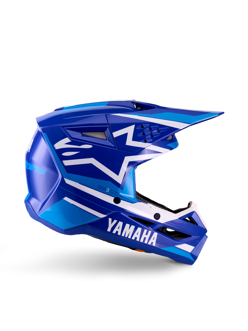 Casque de motocross Yamaha S-M3 Youth, bleu et blanc brillant, vue de profil avec marquage Yamaha imposant et logo étoile Alpinestars, design géométrique avec accents bleu clair, coque ventilée avec longue visière, protection certifiée ECE 22.06