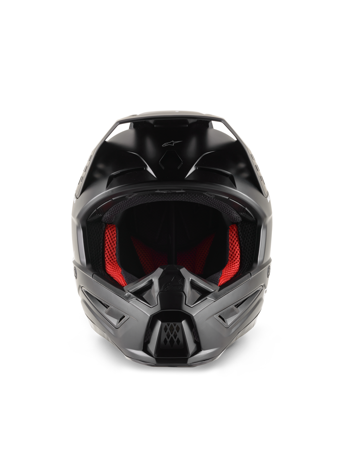 Casque Alpinestars S-M5 Solid, casque de motocross, noir mat, vue de face avec rembourrage intérieur rouge, mentonnière sculptée avec ports de ventilation et visière de protection pour la course tout-terrain