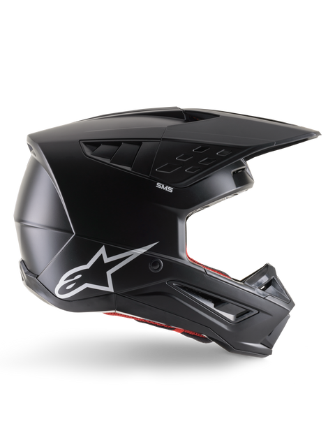 Casque Alpinestars S-M5 Solid, casque de motocross, noir mat, logo étoile Alpinestars blanc et doublure intérieure rouge, design aérodynamique avec multiples évents et visière longue, protection tout-terrain certifiée ECE 22.06