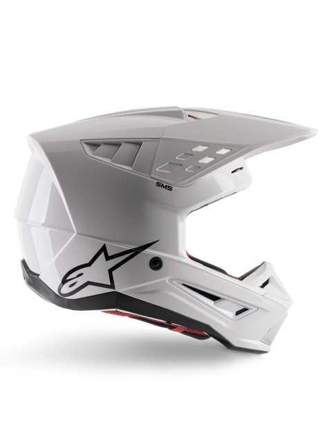 Alpinestars S-M5 Solid Helmet ECE 22.06, casque de motocross, blanc brillant, profil latéral présentant un design aérodynamique angulaire, visière proéminente, aérations intégrées, logo Astars noir à l'arrière et rembourrage intérieur rouge visible