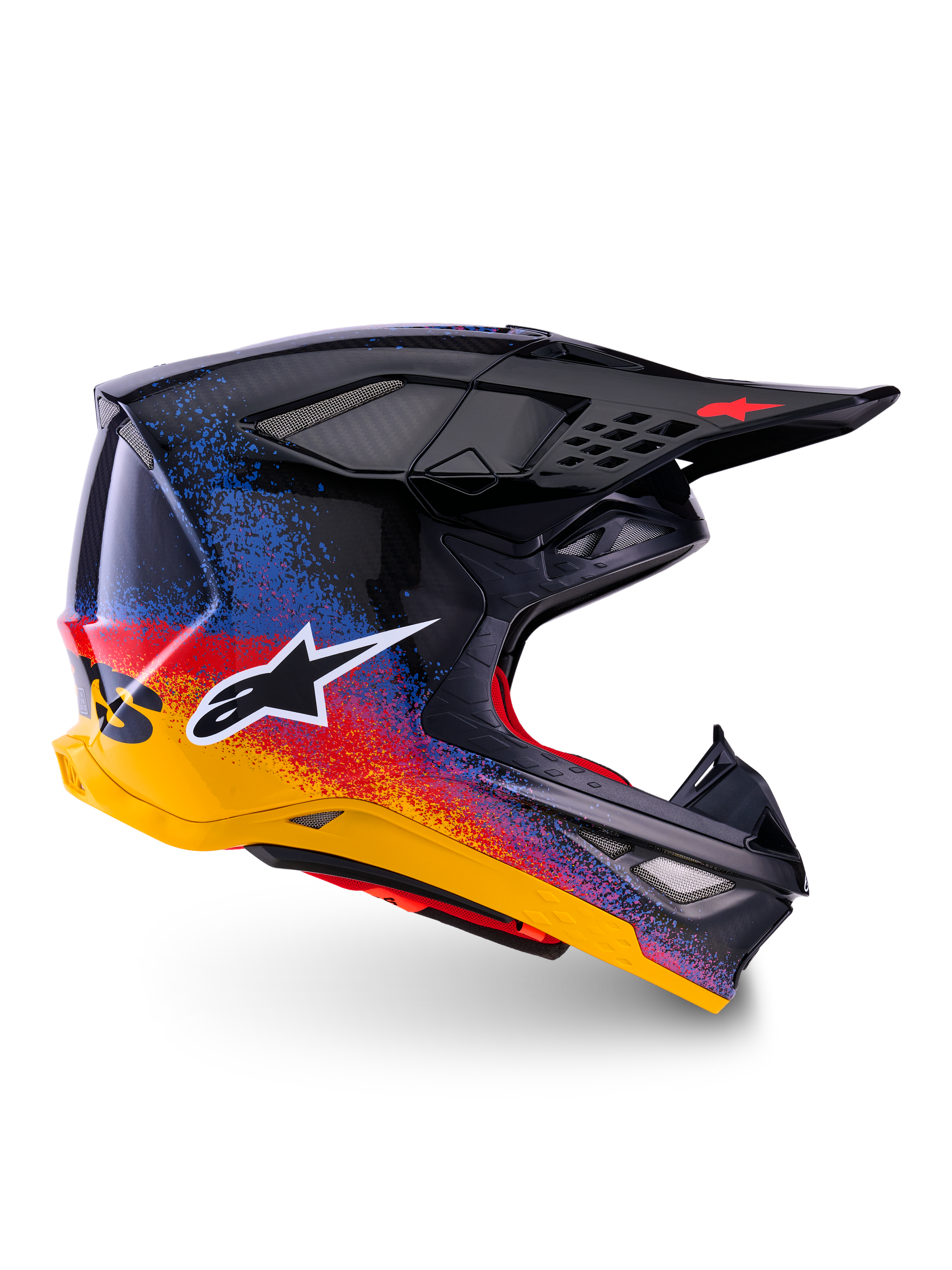 Alpinestars Limited Edition Supertech M10 Black Hole, casque de motocross, coque noire avec motifs d'éclaboussures dégradés rouges, bleus et jaunes, logo étoile blanc sur le côté, profil aérodynamique avec orifices de ventilation grillagés, rembourrage intérieur rouge et longue visière noire