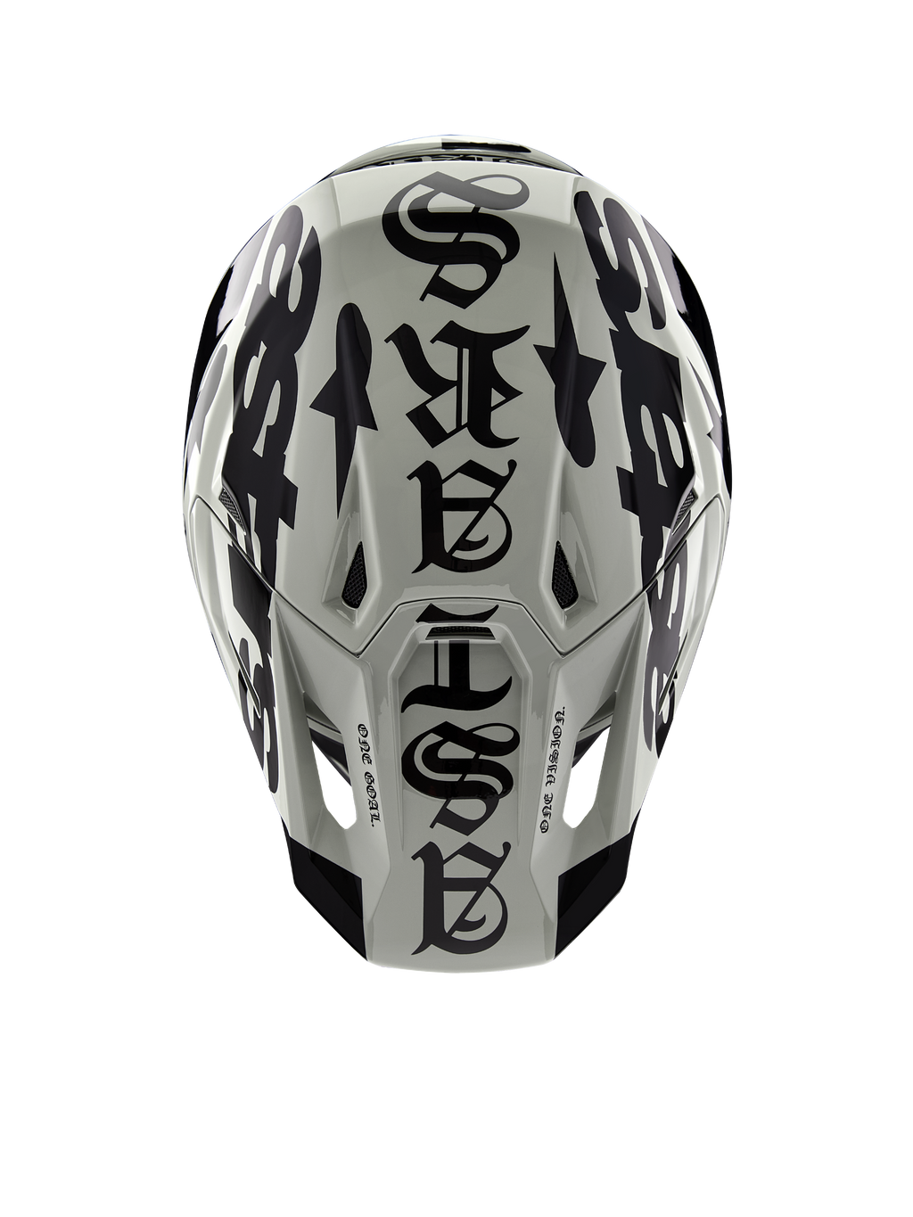 Alpinestars Limited Edition S-M7 Wolf Dust-helm, bovenaanzicht, Dune en zwart glanzende afwerking, met opvallende typografie in gotische stijl over de bovenzijde en One Goal One Vision-details, professionele hoofdbescherming voor motorcross