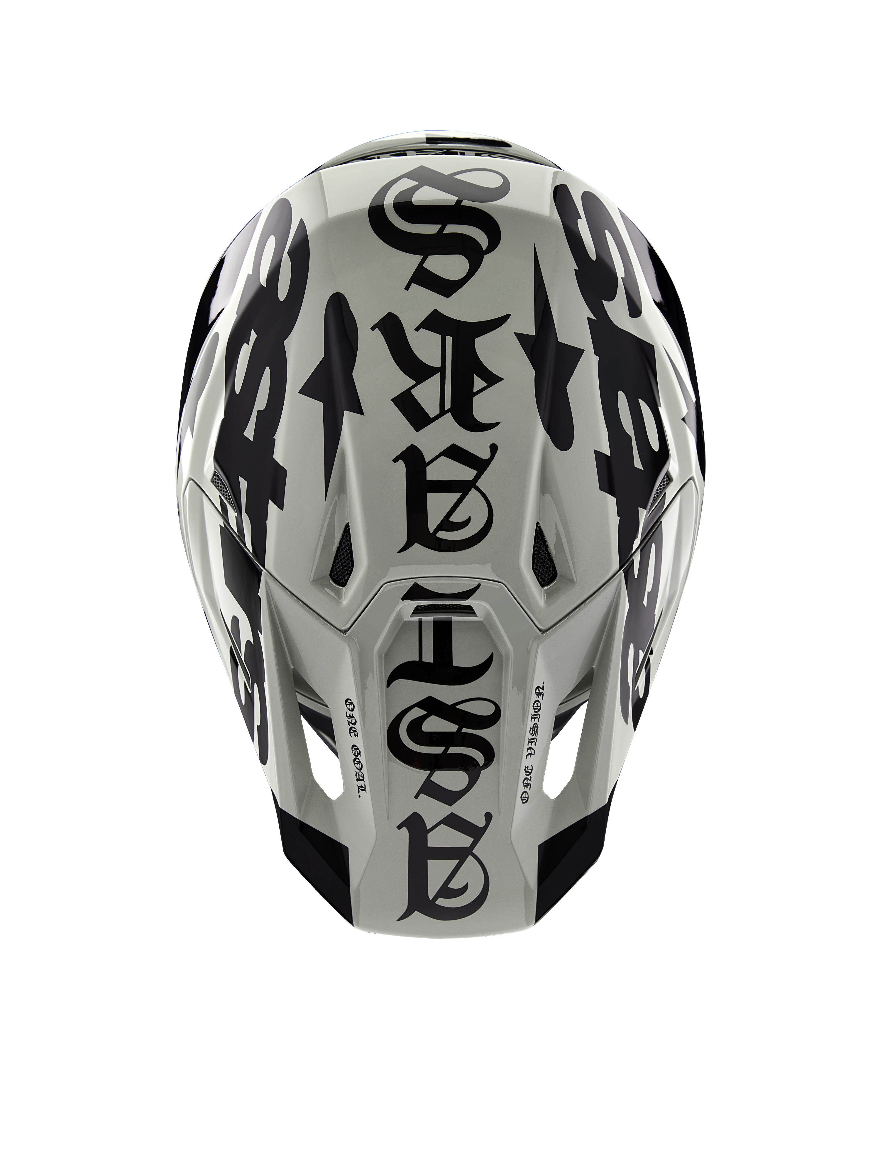 Alpinestars Limited Edition S-M7 Wolf Dust-helm, bovenaanzicht, Dune en zwart glanzende afwerking, met opvallende typografie in gotische stijl over de bovenzijde en One Goal One Vision-details, professionele hoofdbescherming voor motorcross