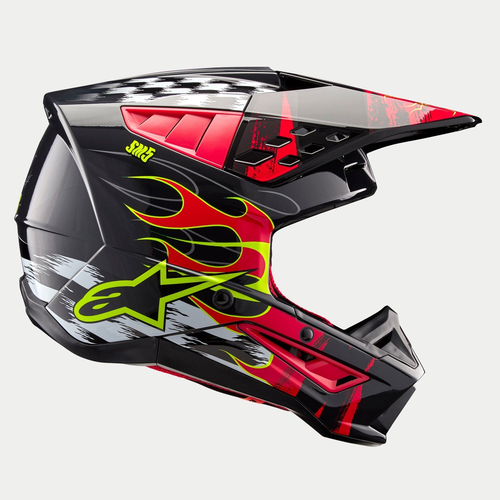 Alpinestars S-M5 Rash Helmet ECE, Motocross Helmet, Dark Gray and Bright Red Glossy, featuring vibrant yellow flame graphics, Alpinestars star logo, checkered patterns on the crown, and white brushstroke accents, high-performance off-road head protection