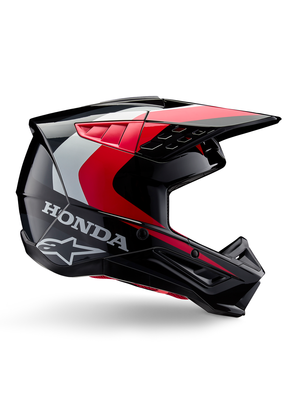 Casque Honda S-M5, casque de motocross, noir et rouge brillant avec accents blancs et argentés, vue latérale présentant les logos Honda et Alpinestars, design aérodynamique avec visière et multiples ports de ventilation, équipement de protection professionnel tout-terrain
