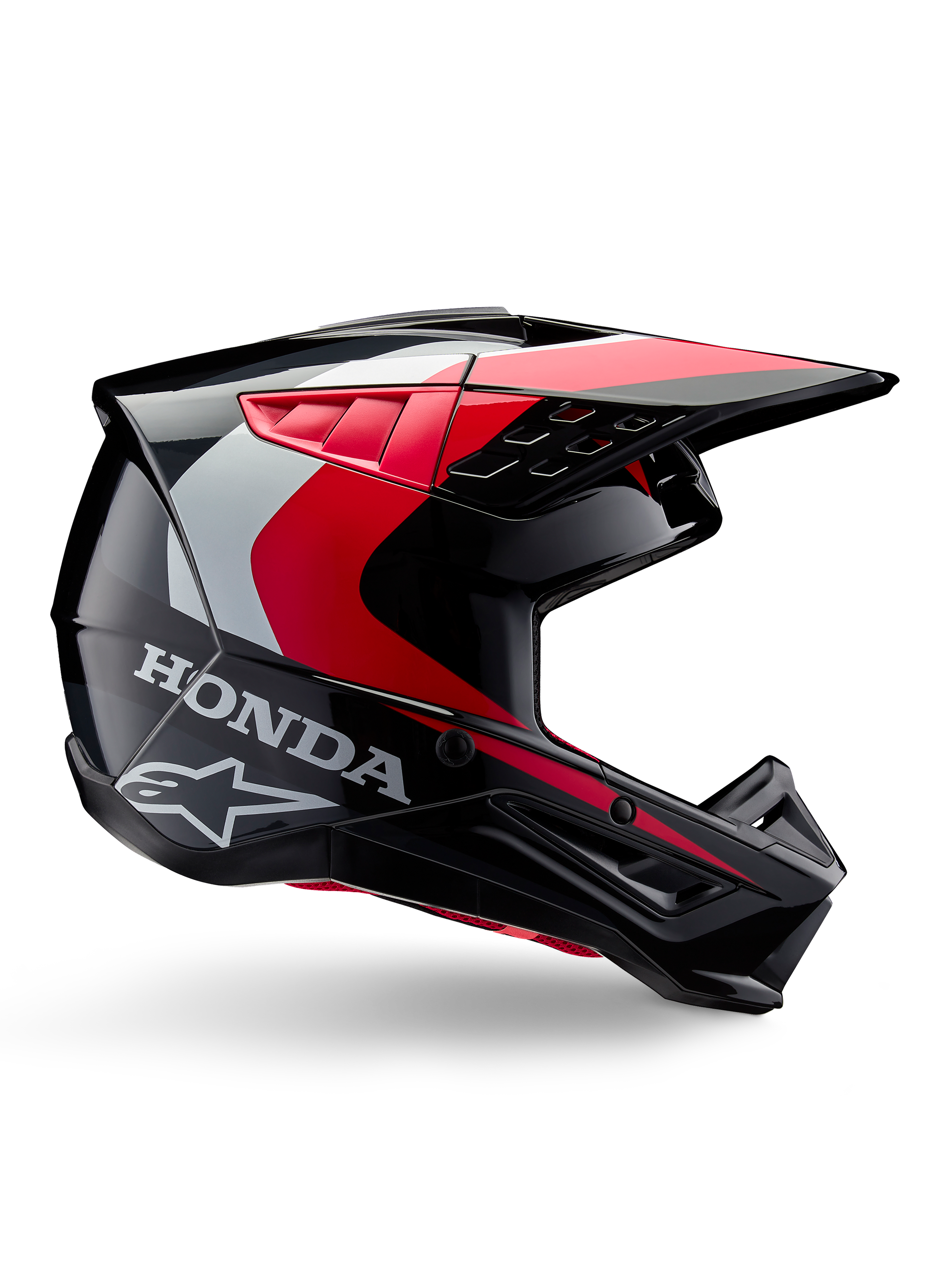 Casque Honda S-M5, casque de motocross, noir et rouge brillant avec accents blancs et argentés, vue latérale présentant les logos Honda et Alpinestars, design aérodynamique avec visière et multiples ports de ventilation, équipement de protection professionnel tout-terrain