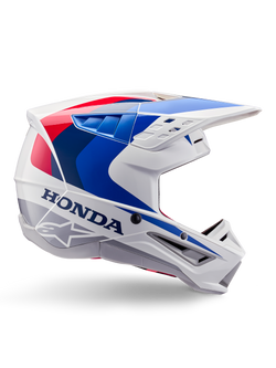 Alpinestars Honda S-M5 Helm ECE, Motocross-Helm, Weiß, Blau und Rot, Seitenprofil-Ansicht, aerodynamisches Design mit integriertem Visier, mehrere Belüftungsöffnungen, glänzendes Finish, markantes Honda-Branding und Alpinestars-Logo