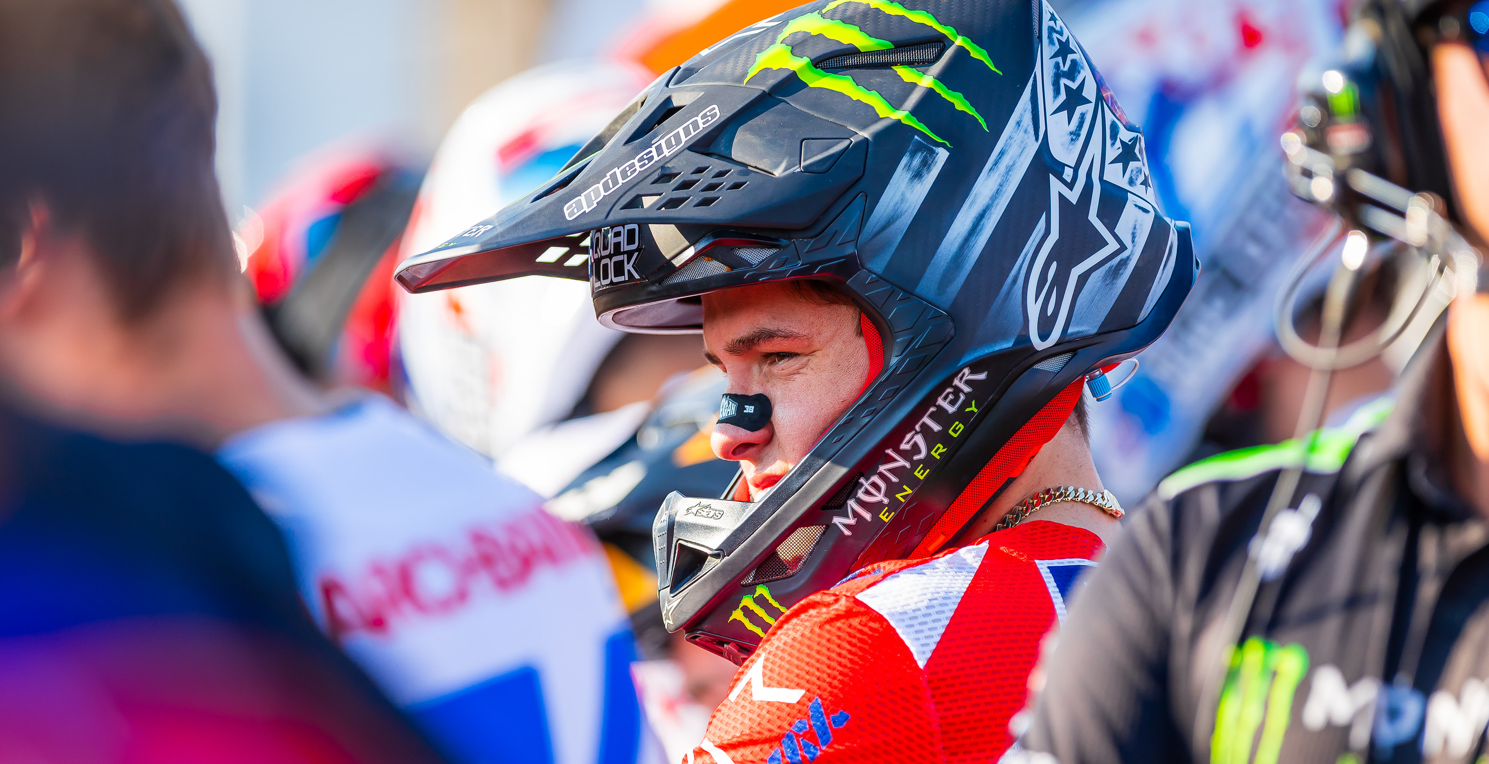 Haiden Deegan wearing a colorful Alpinestars SM10 helmet with branding in an outdoor setting