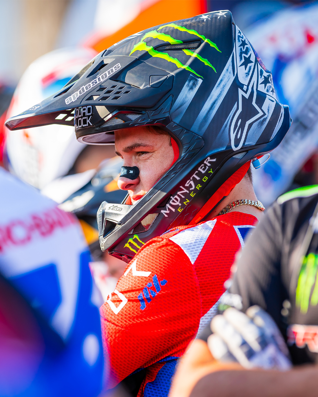 Haiden Deegan wearing a colorful Alpinestars SM10 helmet with branding in an outdoor setting