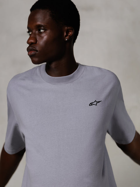 Mannequin portant le T-shirt Alpinestars Essentials Ageless SS, t-shirt à manches courtes, argenté, avec un petit logo noir sur la poitrine, coupe décontractée, design streetwear épuré et minimaliste