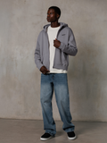 Alpinestars Essentials Ageless Zip Hoodie, Silver, casual streetwear, fleece hoodie met volledige ritssluiting en een klein zwart logo op de borst, gedragen door een model met een wit t-shirt en blauwe jeans, ontspannen lifestyle-pasvorm