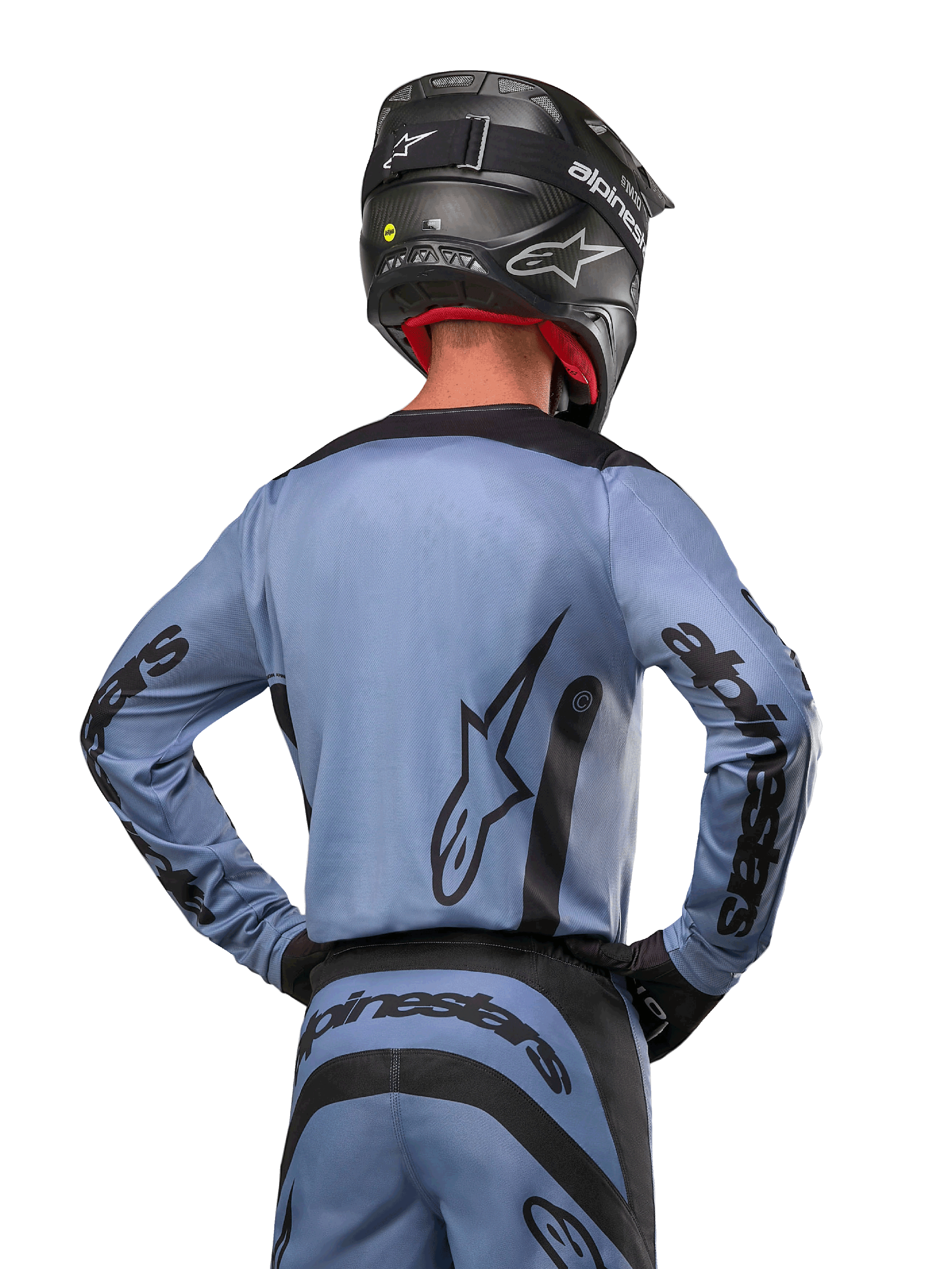 Alpinestars 2024 Fluid Lurv Trikot, Motocross-Trikot, Hellblau und Schwarz, Rückansicht des Fahrers mit großem Stern-Logo und Ärmel-Branding, getragen mit schwarzem Helm und passender Offroad-Hose, professionelle Rennbekleidung