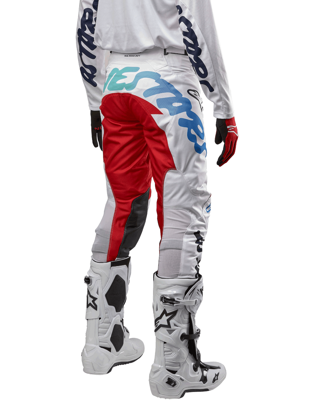 Alpinestars 2024 Racer Hana Pants, Motocross Pants, White Multicolor with red and blue accents, rear view showing large branding on the seat, worn with white and black motocross boots, designed for off-road performance and durability