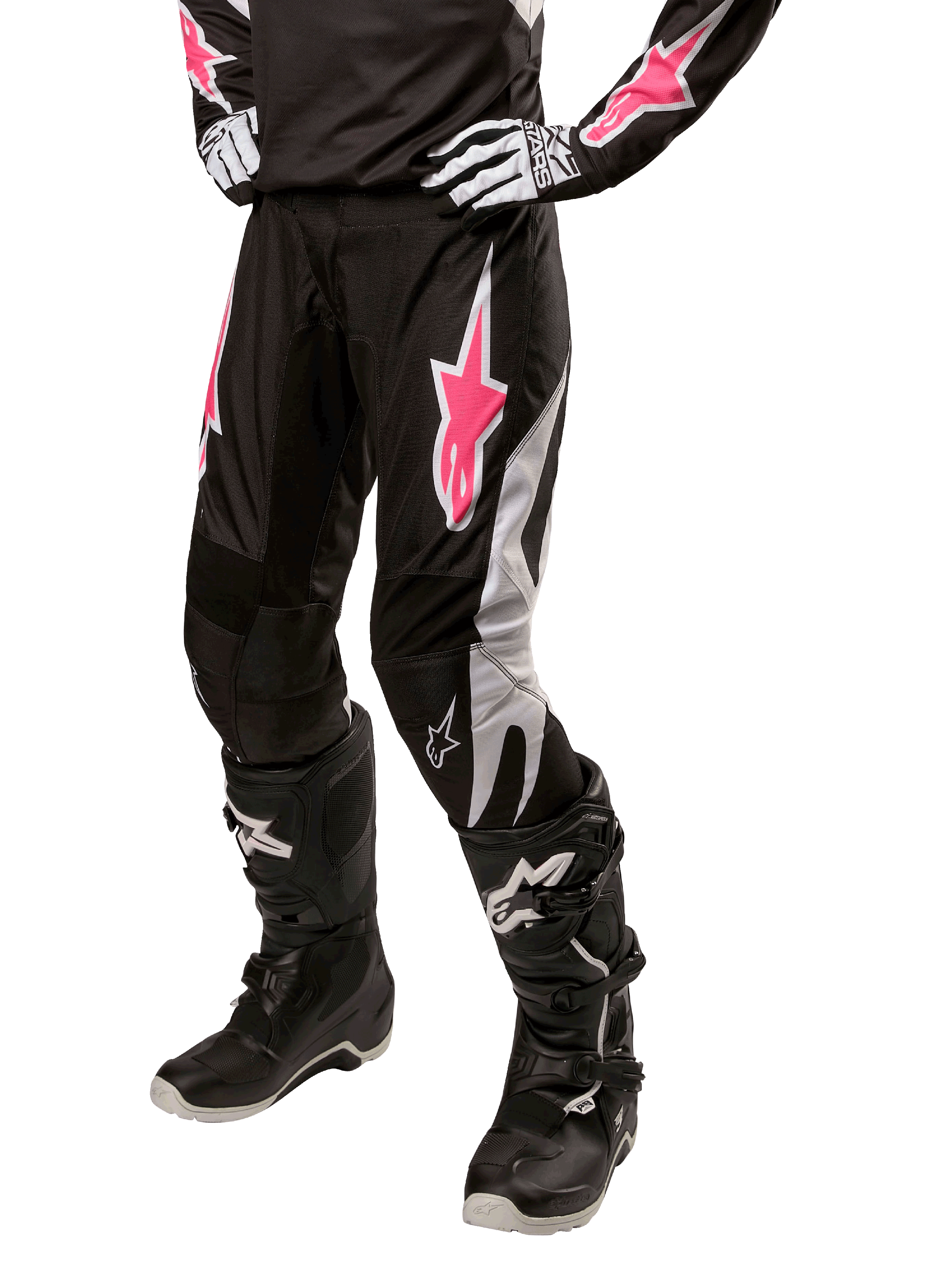 Alpinestars Women Stella 2024 Fluid Pant, Motocross Pants, Black and White with Pink accents, worn with matching protective gear including boots and gloves, durable flexible fabric for off-road riding
