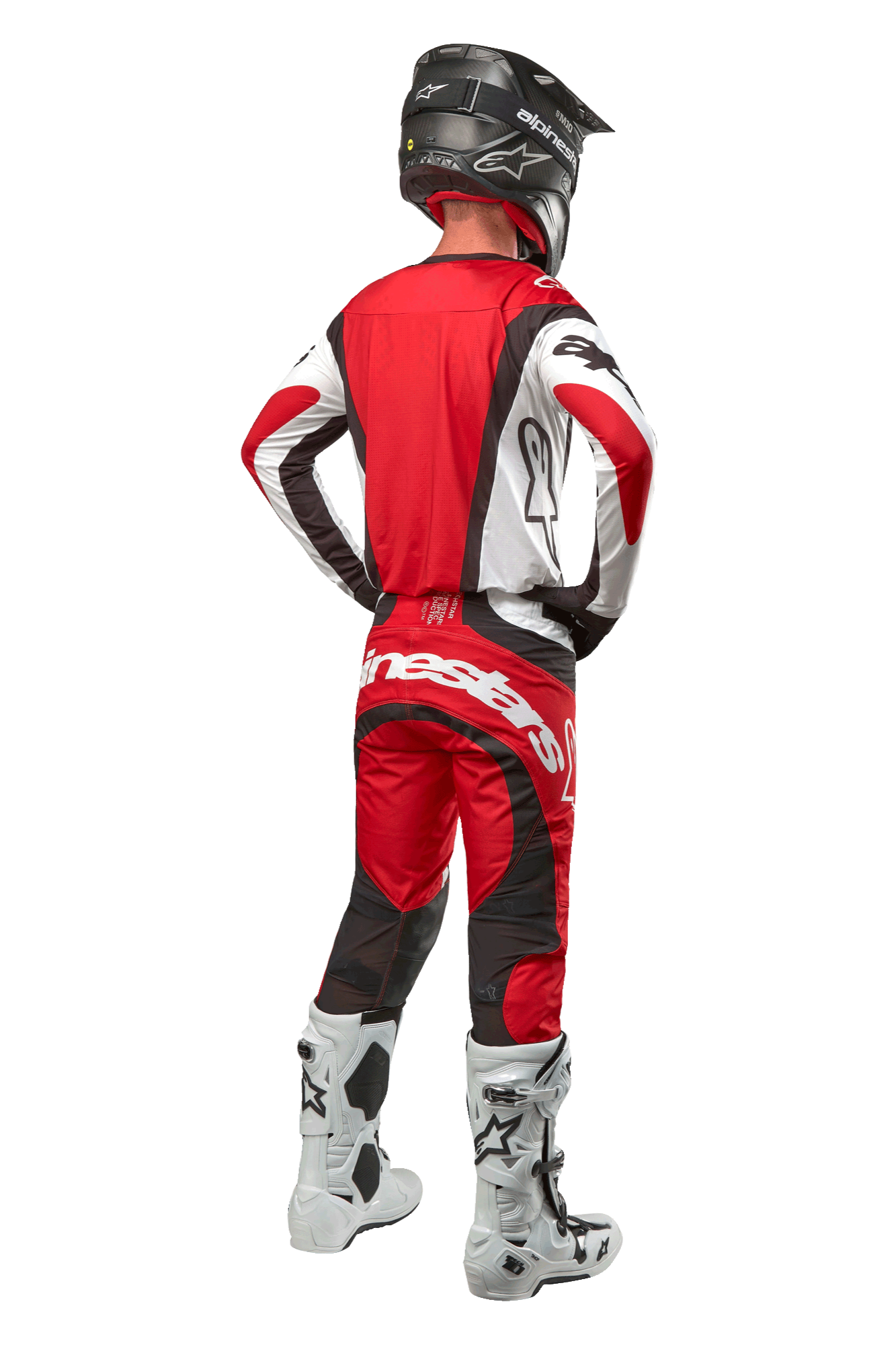 Alpinestars 2024 Techstar Ocuri Pants, pantalon de motocross, Mars Red White Black, vue arrière d'un pilote portant un équipement de course complet, incluant le maillot assorti, un casque noir et des bottes blanches et noires, mettant en avant le logo Alpinestars et la construction en tissu durable.