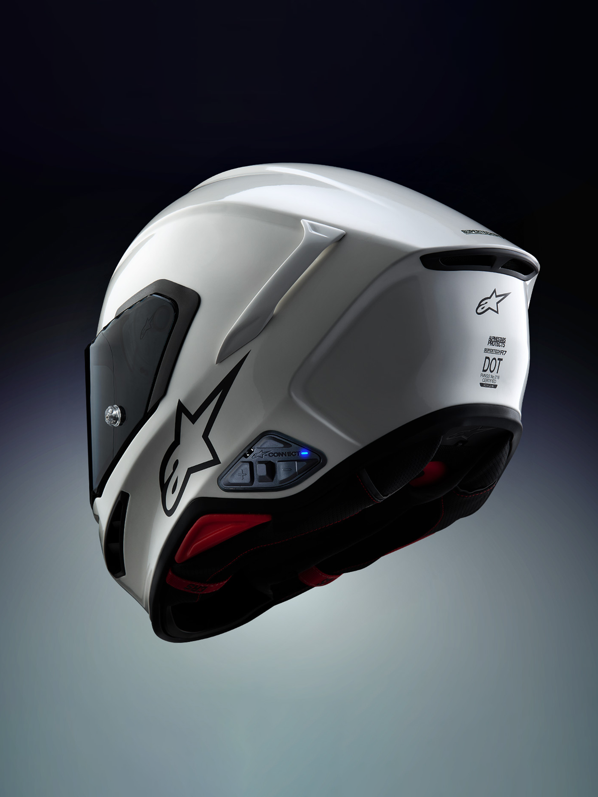 Alpinestars A-Connect Intercom-System, installiert an einem Alpinestars S-R7 Motorradhelm in Weiß und Schwarz, mit Bluetooth-Steuereinheit und blauer LED-Statusleuchte